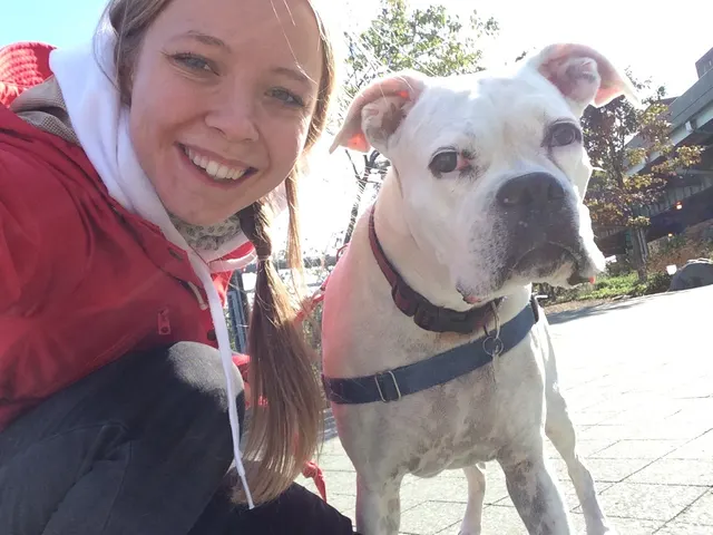 A FurKid walker taking a selfie with a white bulldog